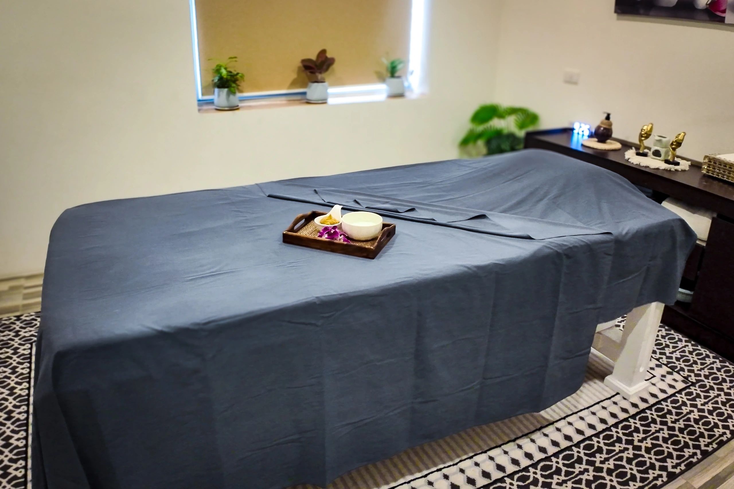 Massage bed prepared with fresh linens and towels
